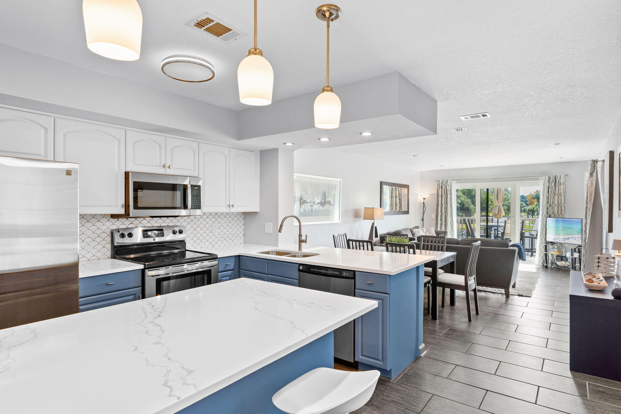 a large kitchen with lots of counter space and stainless steel appliances