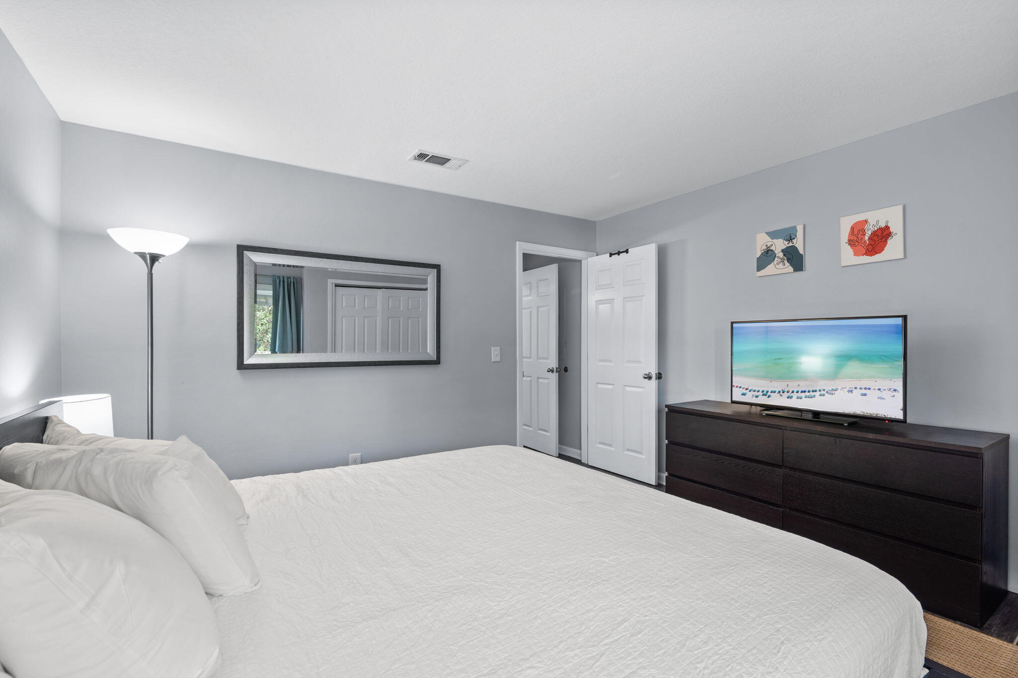 918 Harbour Point Lane, Unit 918 Miramar Beach, FL 32550 - Photo 15 of 43 a bedroom with a bed and a flat screen tv