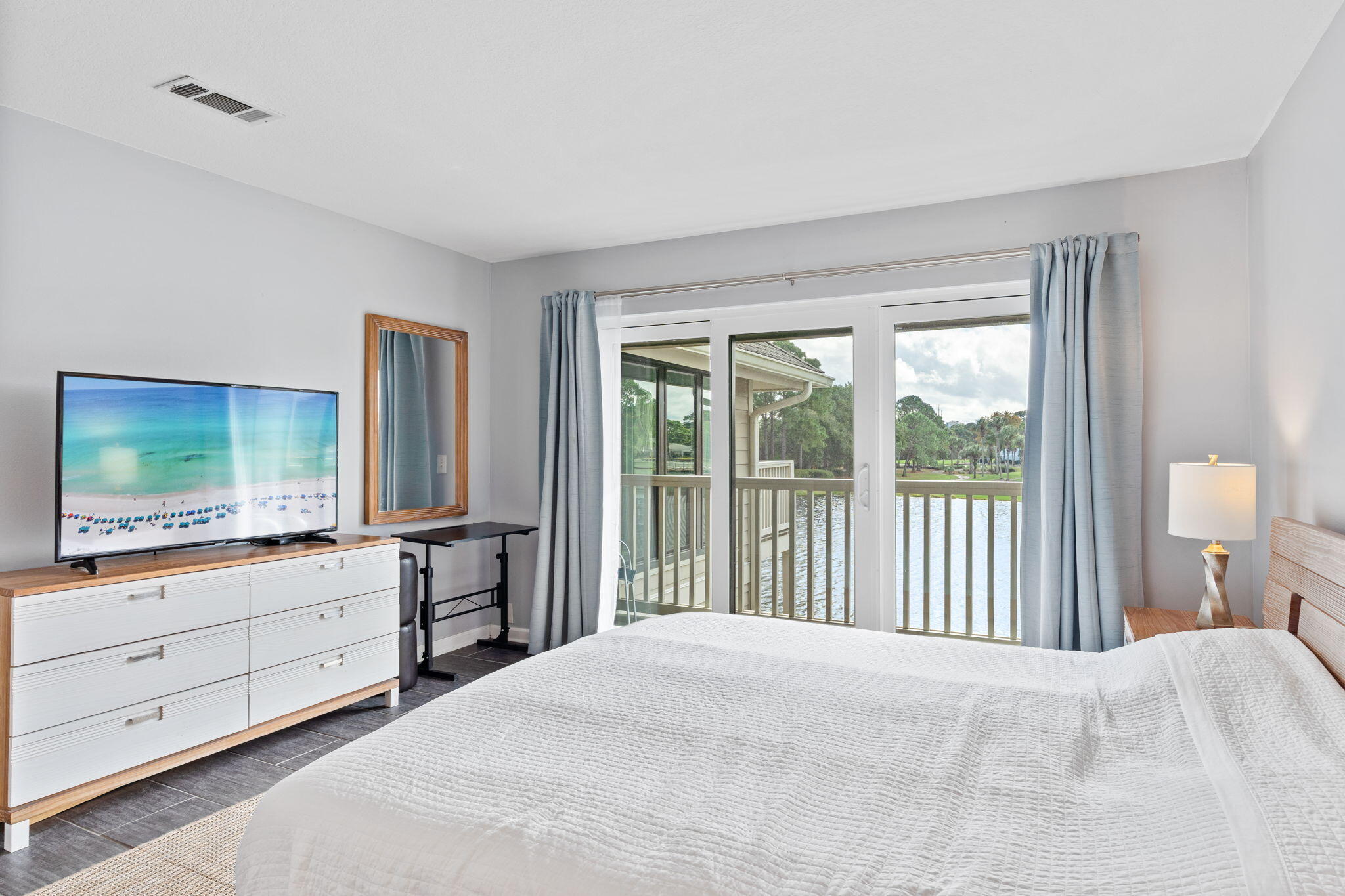918 Harbour Point Lane, Unit 918 Miramar Beach, FL 32550 - Photo 20 of 43 a bedroom with a bed and a flat screen tv