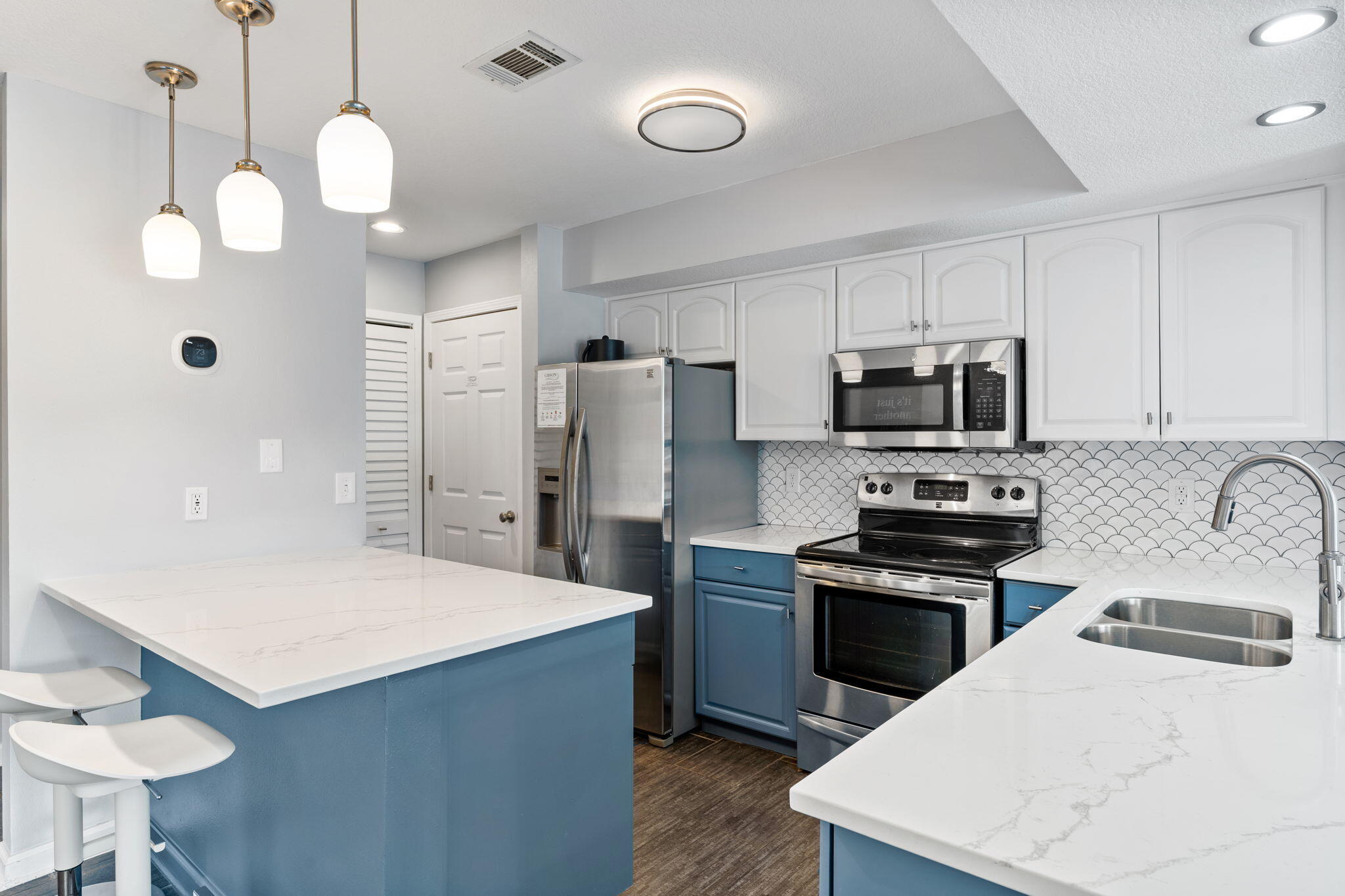 918 Harbour Point Lane, Unit 918 Miramar Beach, FL 32550 - Photo 2 of 43 a kitchen with stainless steel appliances a stove refrigerator and microwave