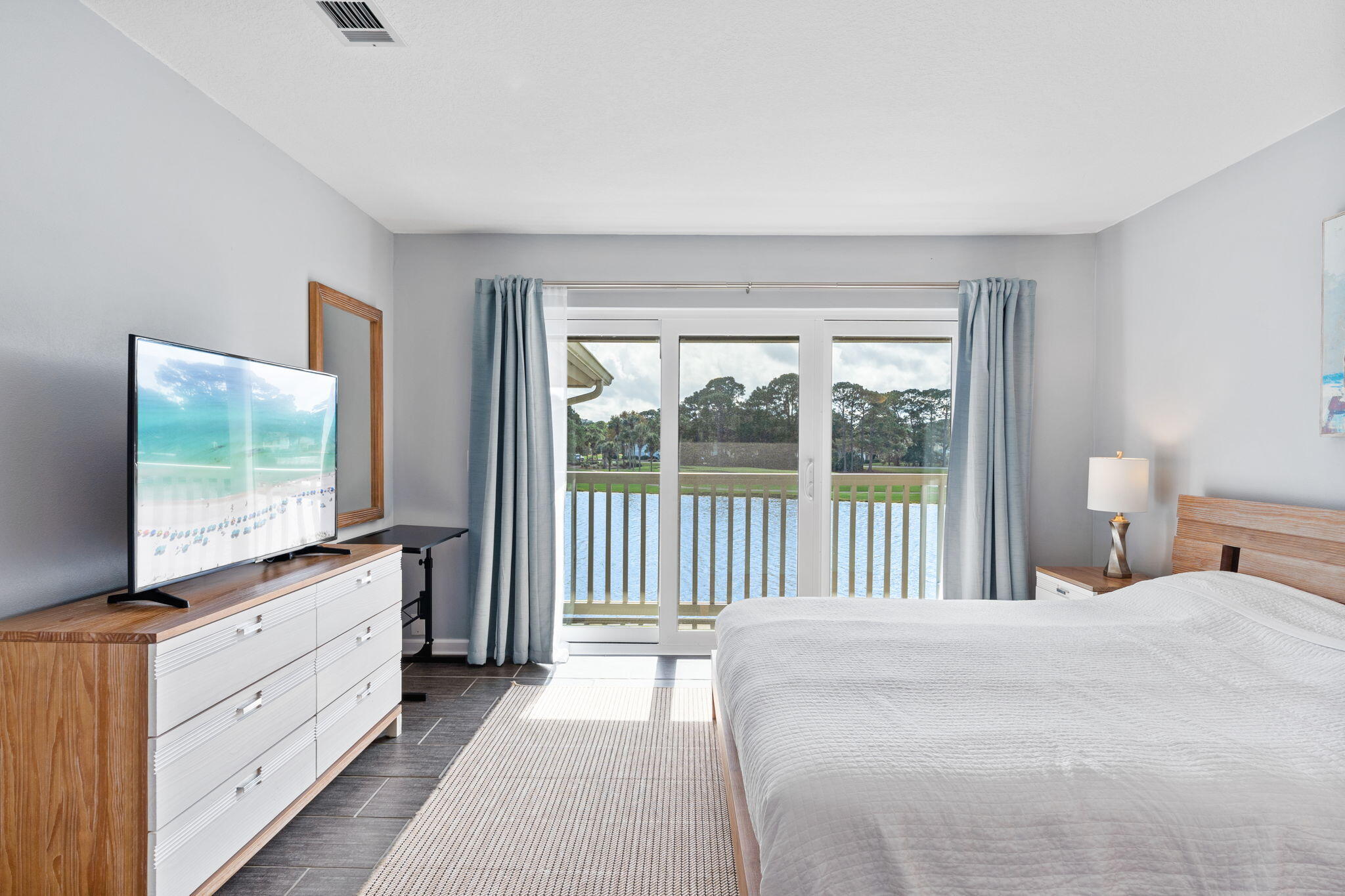 918 Harbour Point Lane, Unit 918 Miramar Beach, FL 32550 - Photo 21 of 43 a room with a bed and a flat tv screen on dresser