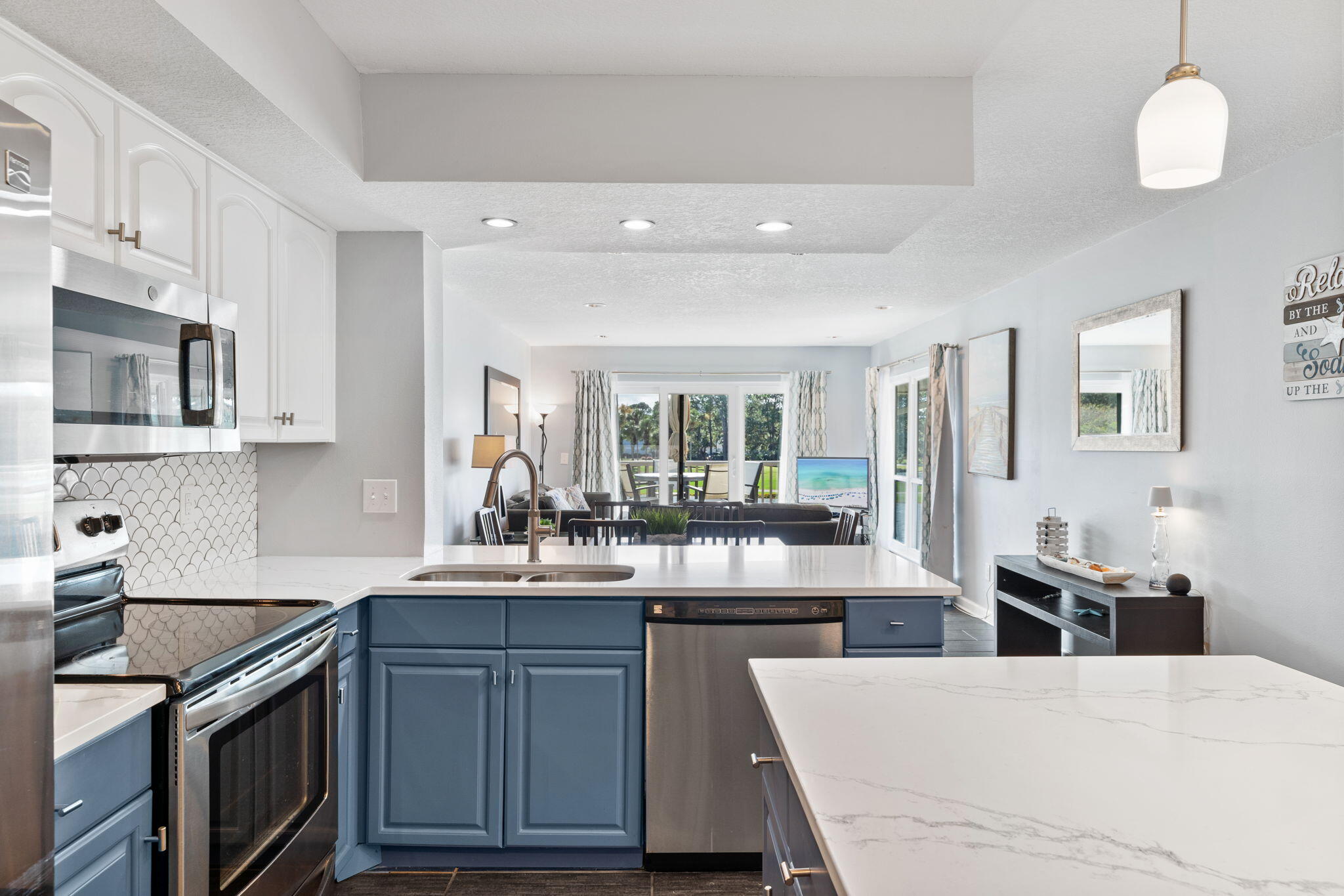 918 Harbour Point Lane, Unit 918 Miramar Beach, FL 32550 - Photo 27 of 43 a kitchen with kitchen island granite countertop a stove and a sink