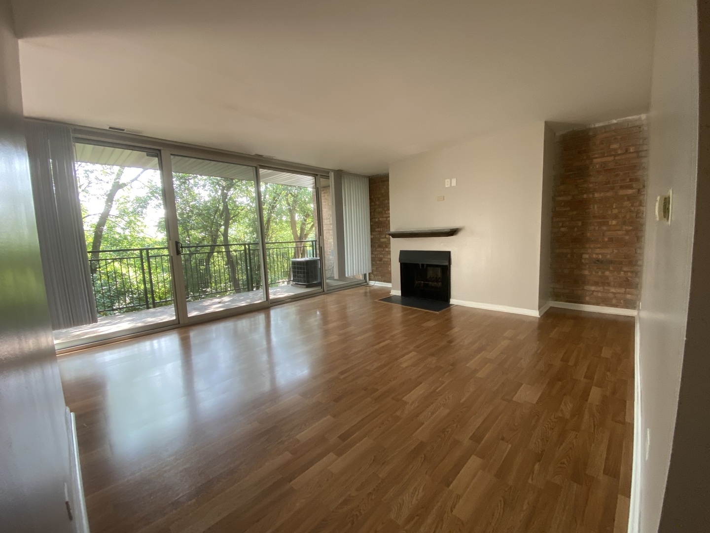 5904 Forest View Road, Unit 2F Lisle, IL 60532 - Photo 1 of 10 wooden floor in an empty room with a fireplace