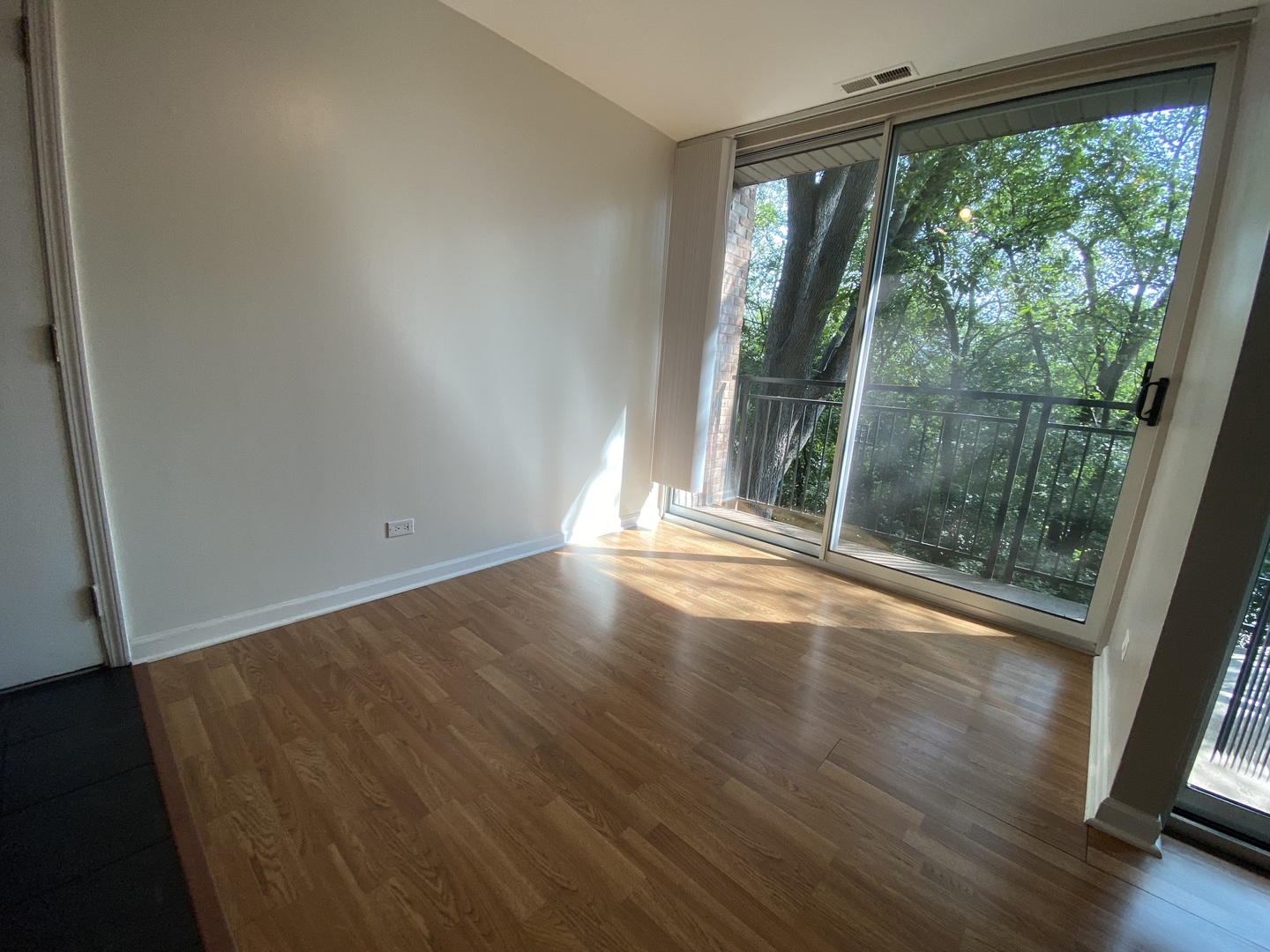 5904 Forest View Road, Unit 2F Lisle, IL 60532 - Photo 3 of 10 a view of empty room with wooden floor and fan