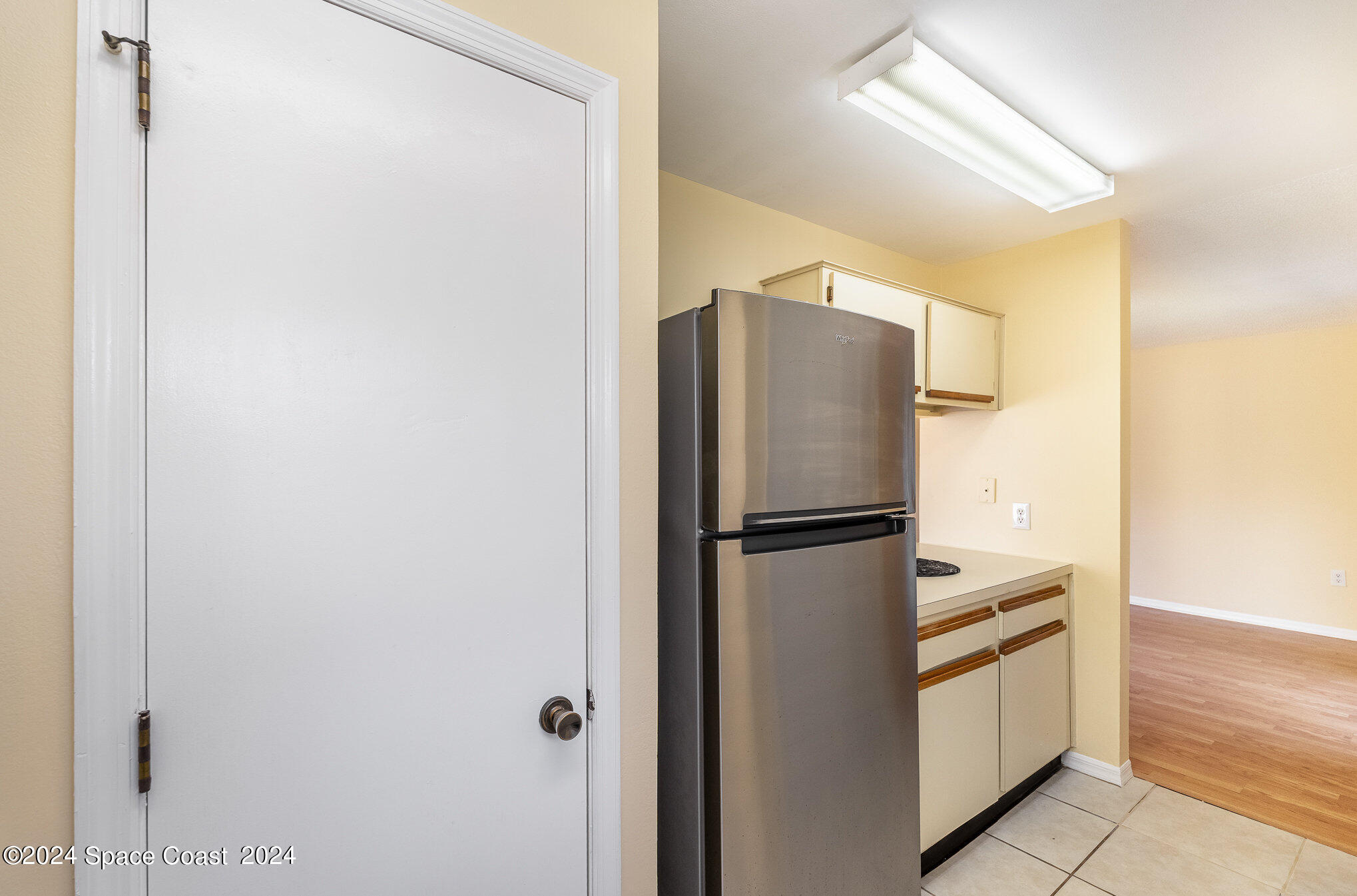 280 Spring Drive, Unit 8 Merritt Island, FL 32953 - Photo 13 of 26 a white refrigerator freezer and a stove sitting inside of a kitchen