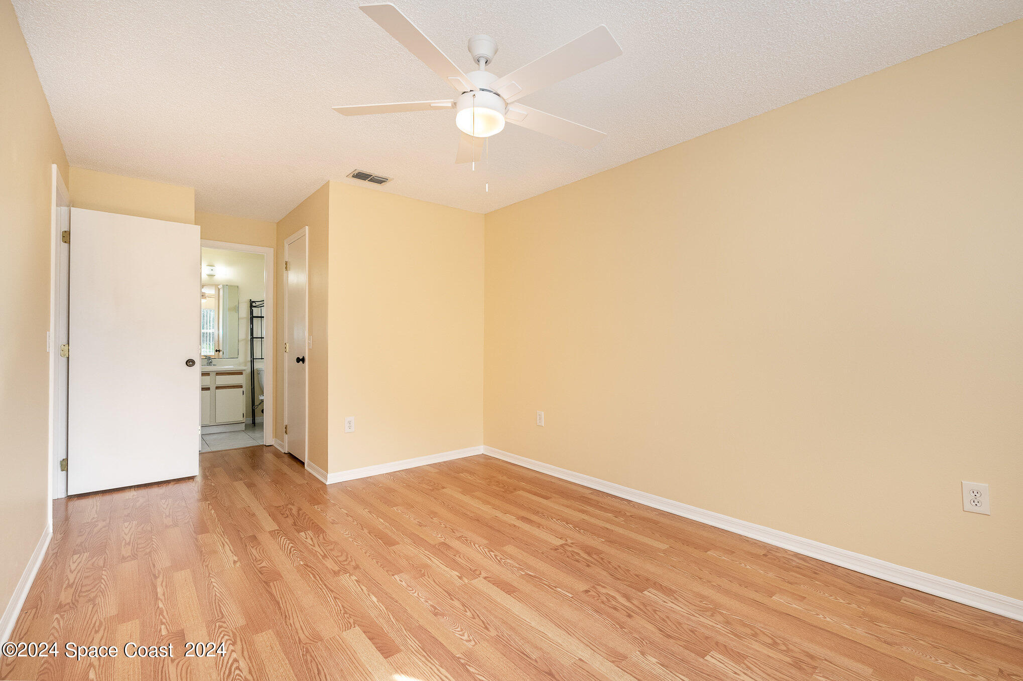 280 Spring Drive, Unit 8 Merritt Island, FL 32953 - Photo 20 of 26 a view of a big room with wooden floor and a kitchen