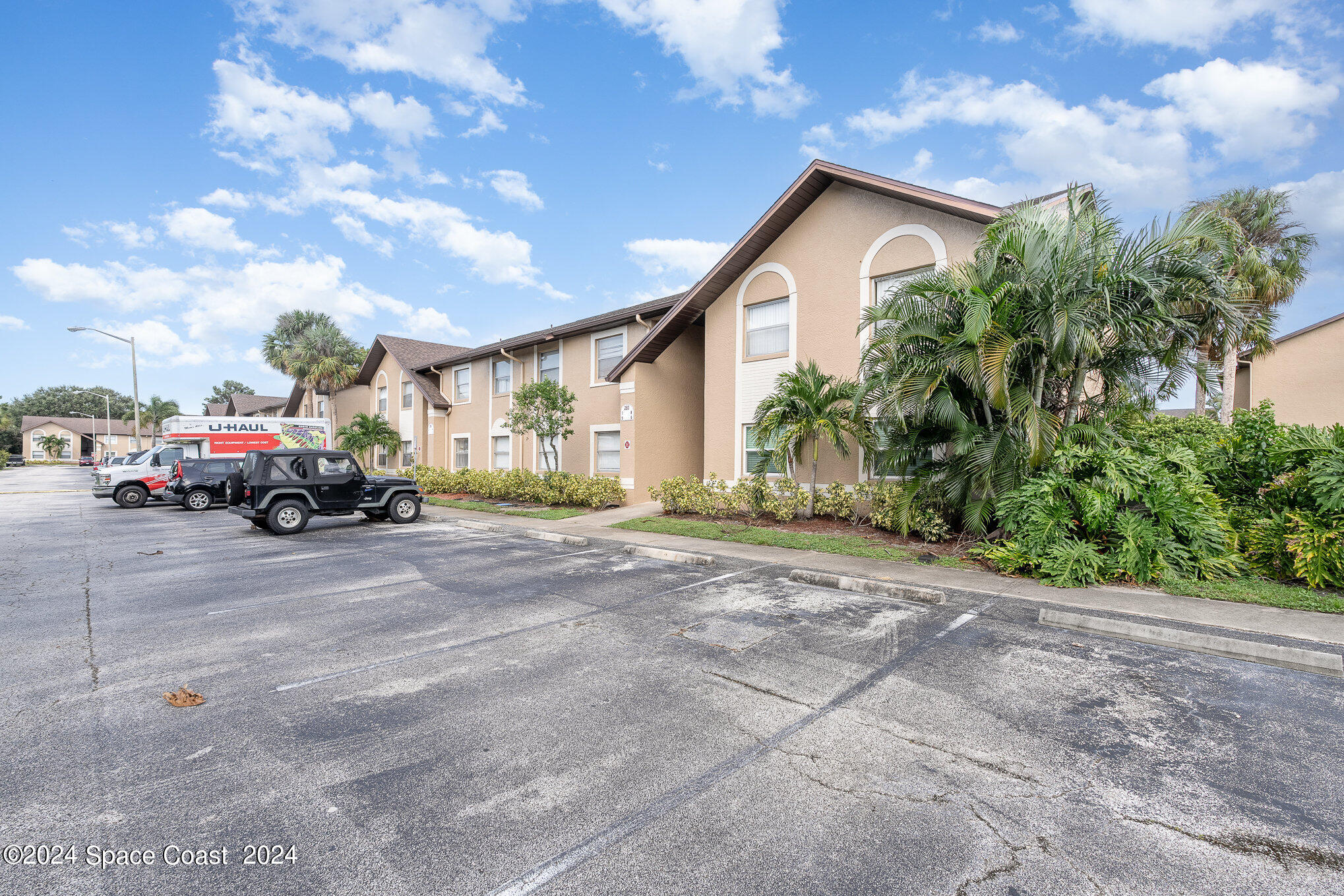 280 Spring Drive, Unit 8 Merritt Island, FL 32953 - Photo 2 of 26 a car parked in front of house with a yard