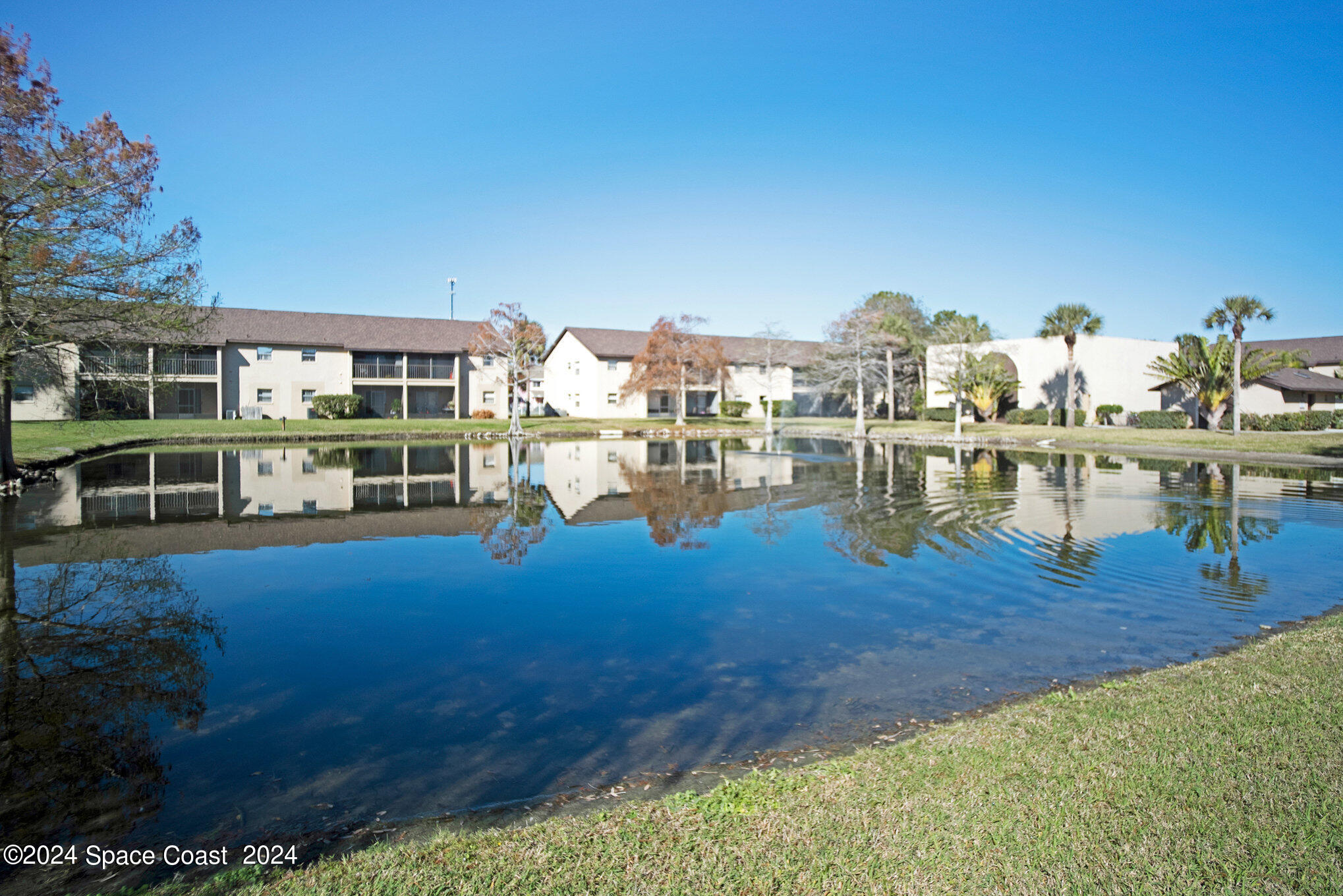 280 Spring Drive, Unit 8 Merritt Island, FL 32953 - Photo 22 of 26 a view of a swimming pool with seating area