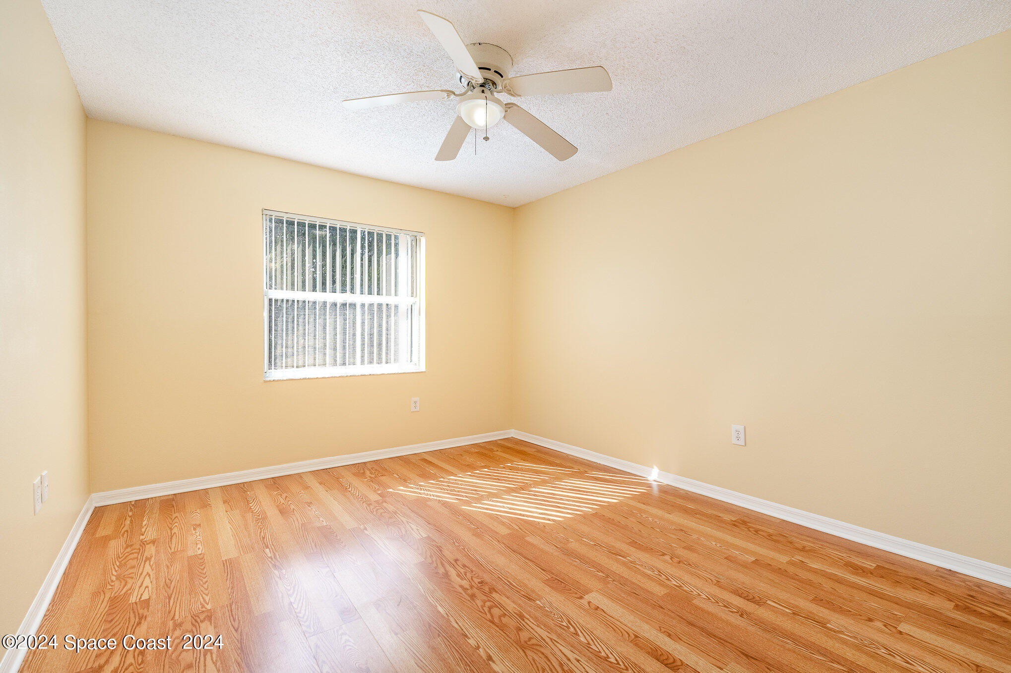 280 Spring Drive, Unit 8 Merritt Island, FL 32953 - Photo 23 of 26 an empty room with a window and a ceiling fan