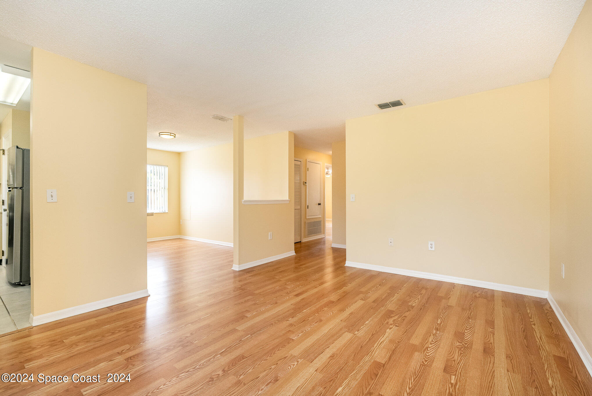 280 Spring Drive, Unit 8 Merritt Island, FL 32953 - Photo 10 of 26 a view of an empty room and wooden floor