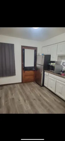 a view of a room with furniture and a lamp