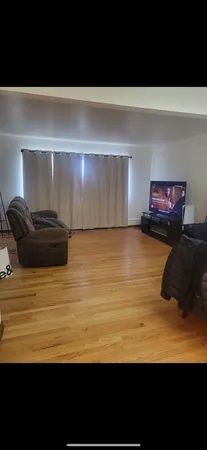 a bedroom with a bed and a night stand