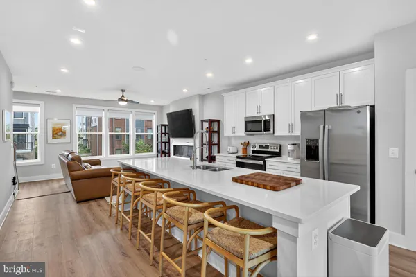 a kitchen with stainless steel appliances granite countertop a refrigerator stove microwave and sink