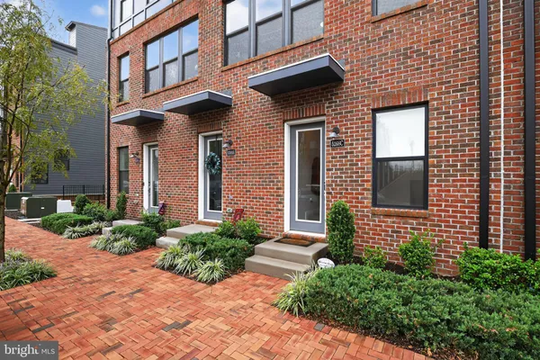 a view of a brick building next to a yard