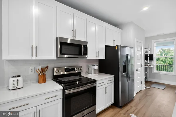 a kitchen with a refrigerator stove and sink