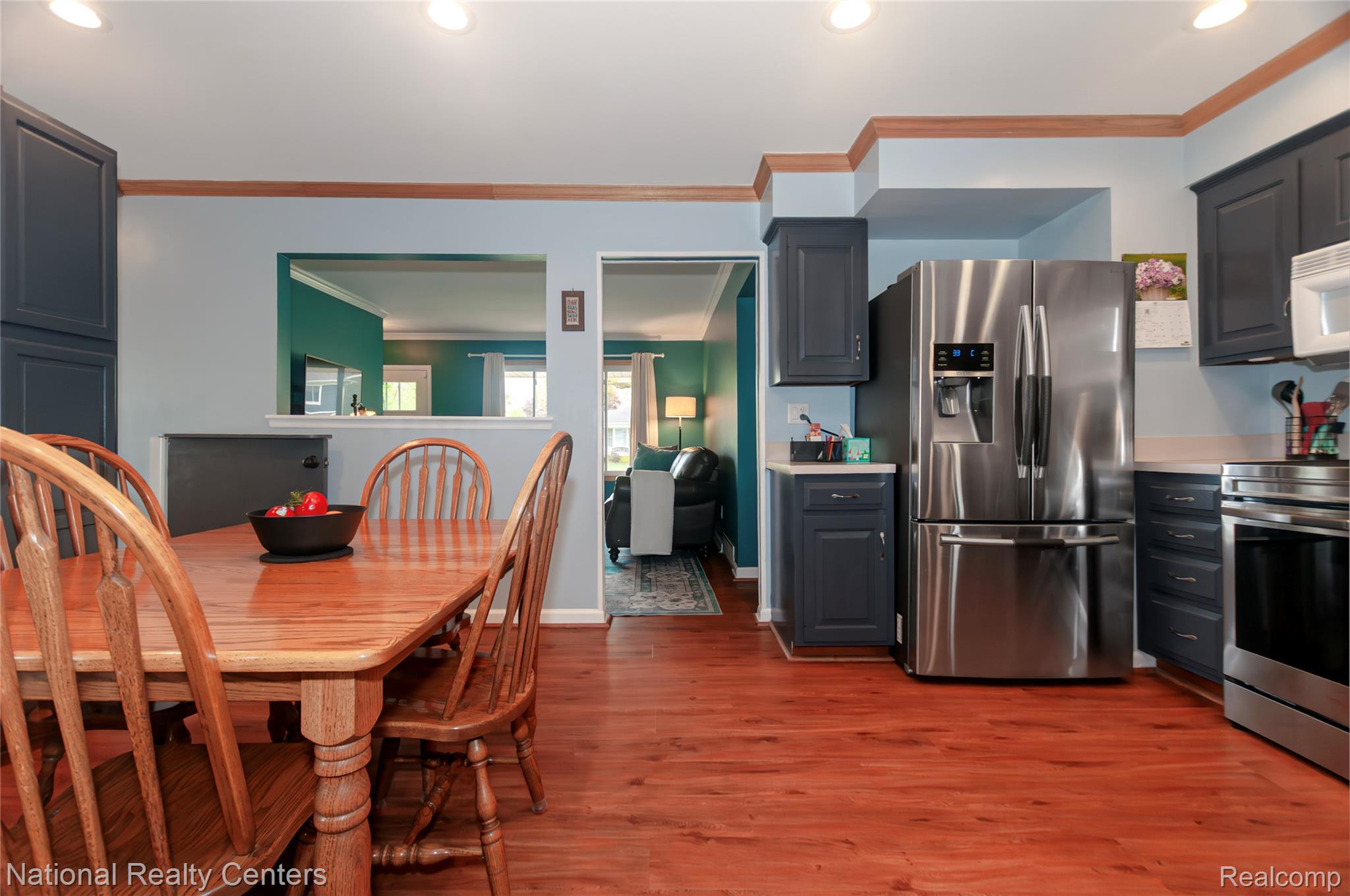 2446 Milverton Road Troy, MI 48083 - Photo 12 of 41 Kitchen featuring stainless steel appliances, crown molding, light countertops, dark wood-type flooring, and recessed lighting