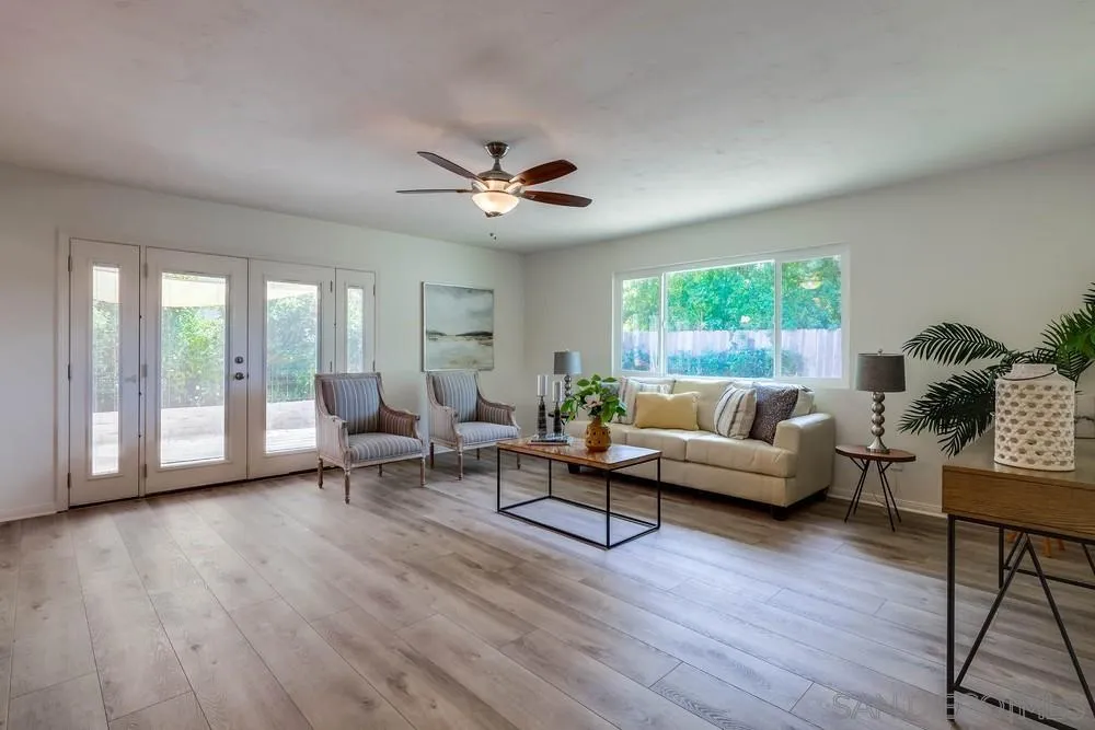 12711 Rios Road San Diego, CA 92128 - Photo 8 of 33 a living room with furniture and a large window