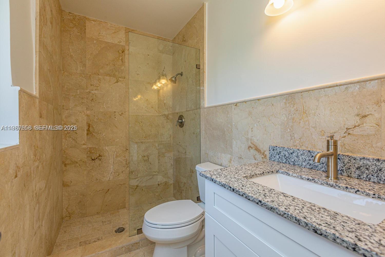 2882 South Le Jeune Road, Unit 2882 Coral Gables, FL 33134 - Photo 10 of 18 Marble floor and walls in the bathrooms