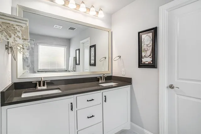 a bathroom with white tub a window and a shower