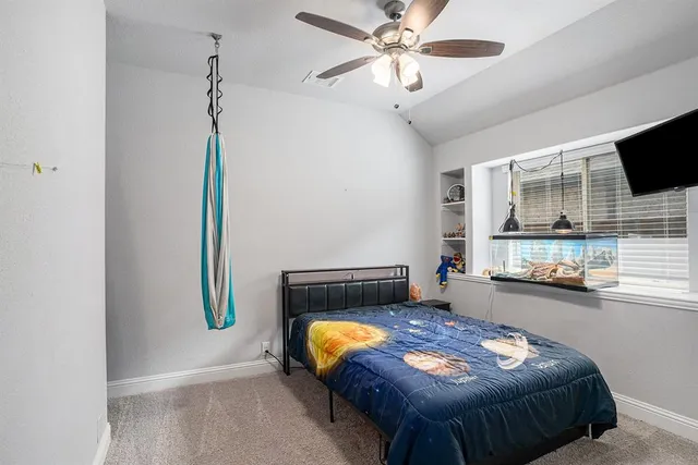 a bedroom that has a bed and a window in it