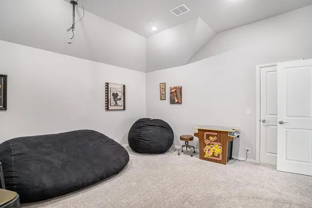 a bedroom with a bed next to a window