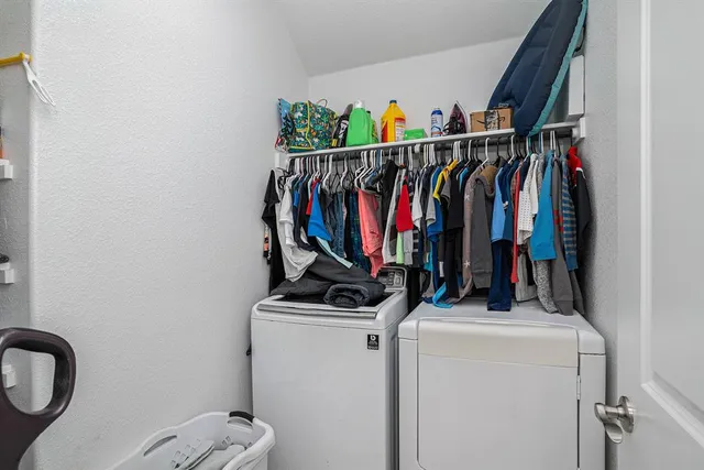 a bathroom with a sink a toilet a mirror and shower curtain