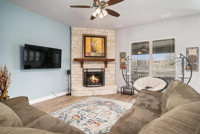 a living room with a couch a flat screen tv and a fireplace