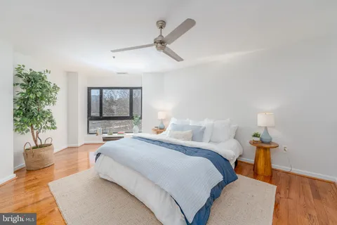 a bedroom with a bed and a potted plant
