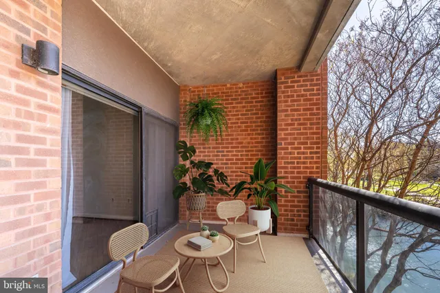 a view of a balcony with chairs and a stove