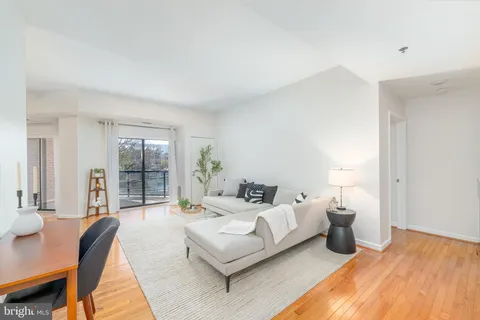 a bedroom with furniture and a large window