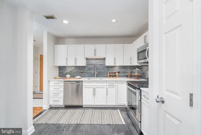 a kitchen with a white cabinets and white appliances