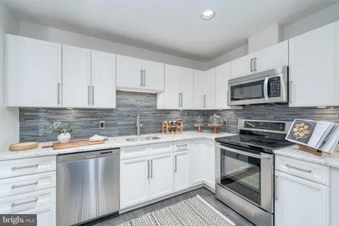 a kitchen with a sink stove and microwave