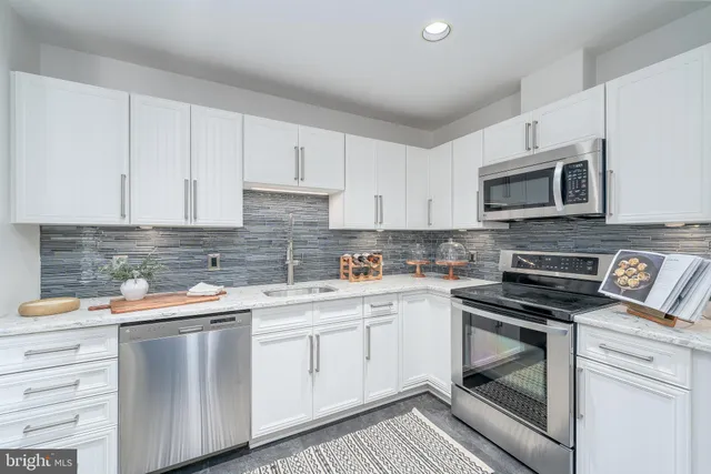 a kitchen with a sink stove and microwave
