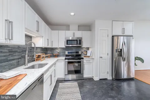 a kitchen with a refrigerator and a sink