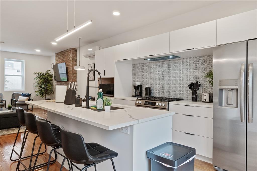 1240 Butterfield Way Pittsburgh, PA 15212 - Photo 12 of 35 a kitchen with a table chairs stove and refrigerator
