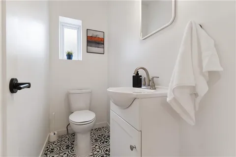a view of a storage and utility room with wooden floor