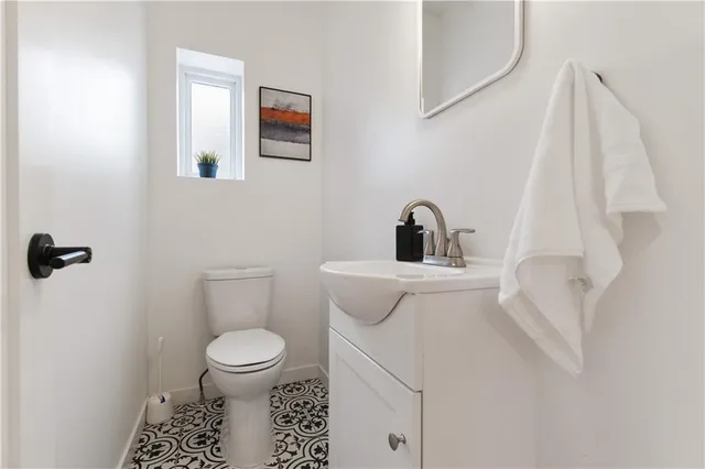 a view of a storage and utility room with wooden floor