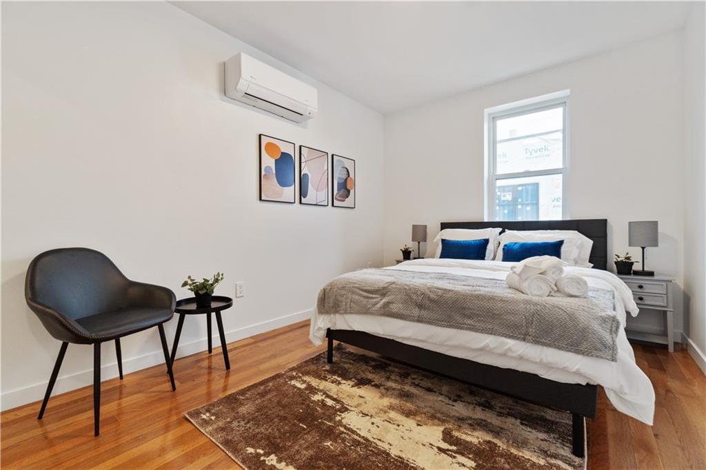 1240 Butterfield Way Pittsburgh, PA 15212 - Photo 24 of 35 a bedroom with a bed and a chair