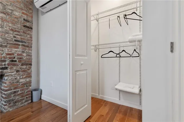 a view of a room with wooden floor and white walls