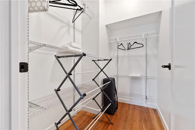 a spacious bedroom with two beds and a desk