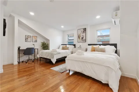 a bedroom with a bed and a potted plant