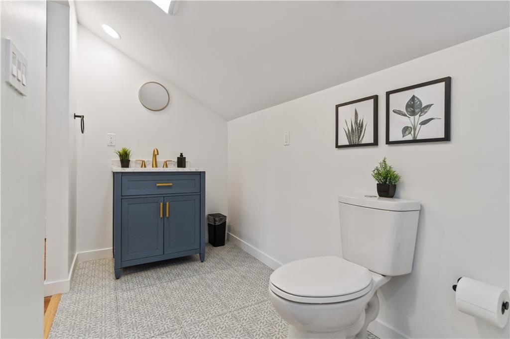 1240 Butterfield Way Pittsburgh, PA 15212 - Photo 34 of 35 a bathroom with a toilet a sink and mirror