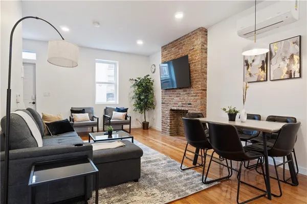a living room with furniture a fireplace and a flat screen tv