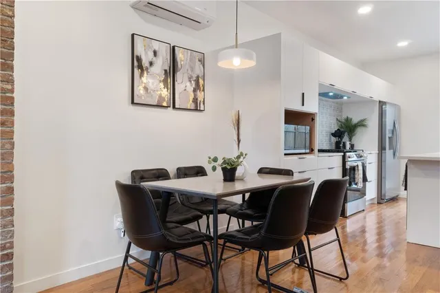 a view of a dining room with furniture and wooden floor