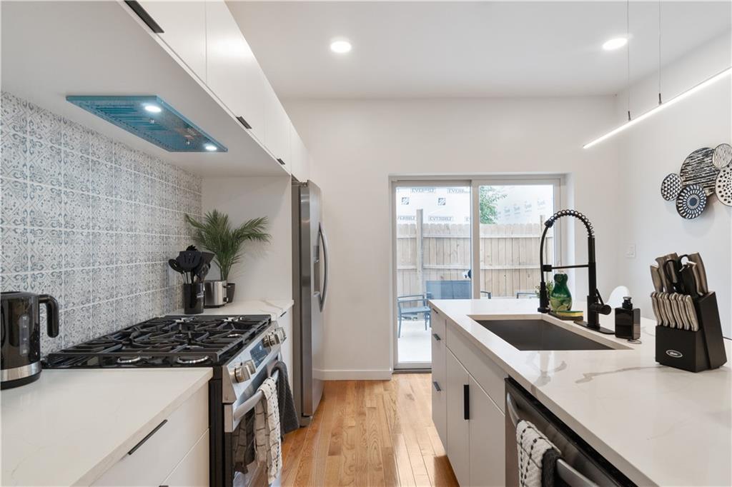 1240 Butterfield Way Pittsburgh, PA 15212 - Photo 9 of 35 a kitchen with a sink and a stove top oven