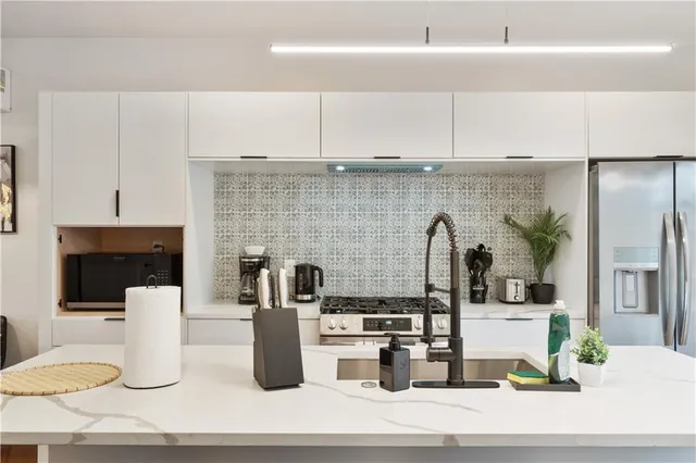 a kitchen with a refrigerator and a stove