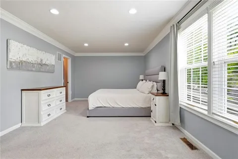 a bedroom with a bed and window