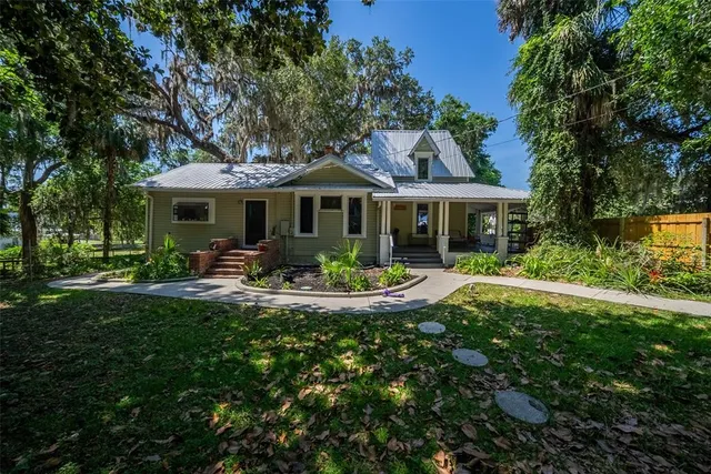 a front view of a house with yard patio and green space
