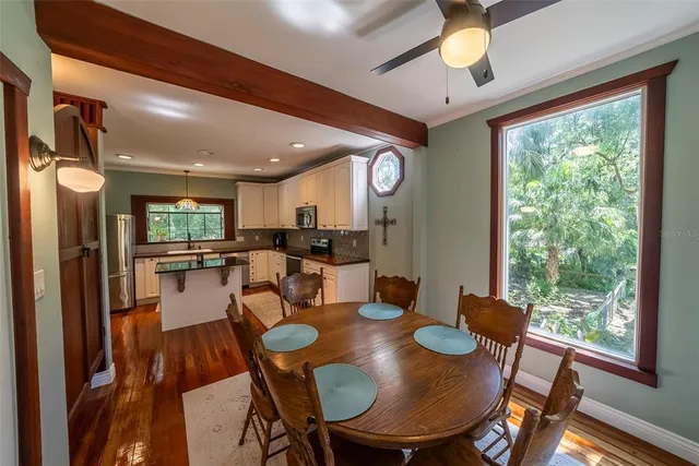a bathroom with a sink a mirror a toilet and a window