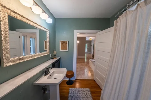 a living room with furniture and a book shelf